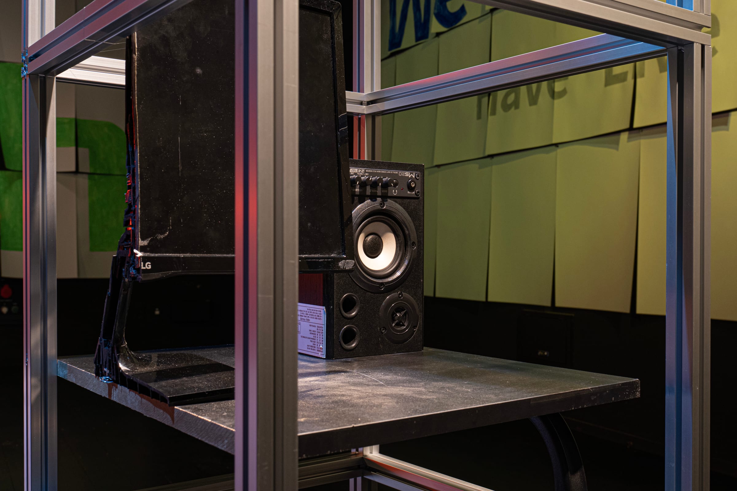Monitor and speaker held in the aluminum frame